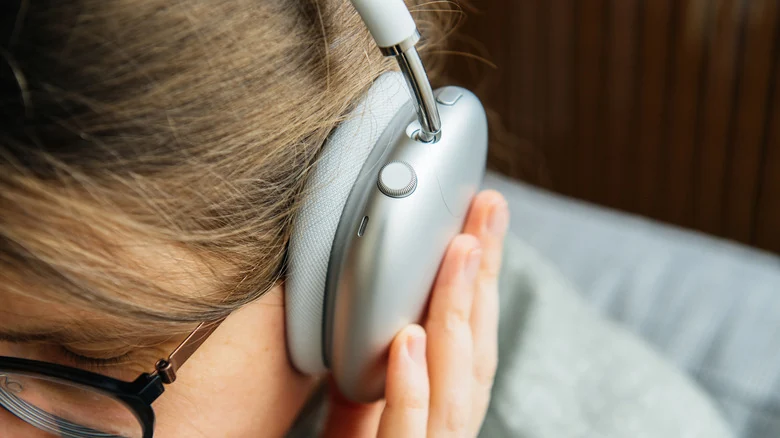 A person wearing Apple AirPods Max.