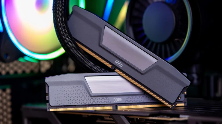 Two DDR5 RAM sticks with a PC in the foreground.
