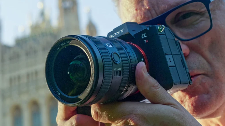 The Sony A7R VI is shown being used by a person in front of the London parliament buildings.
